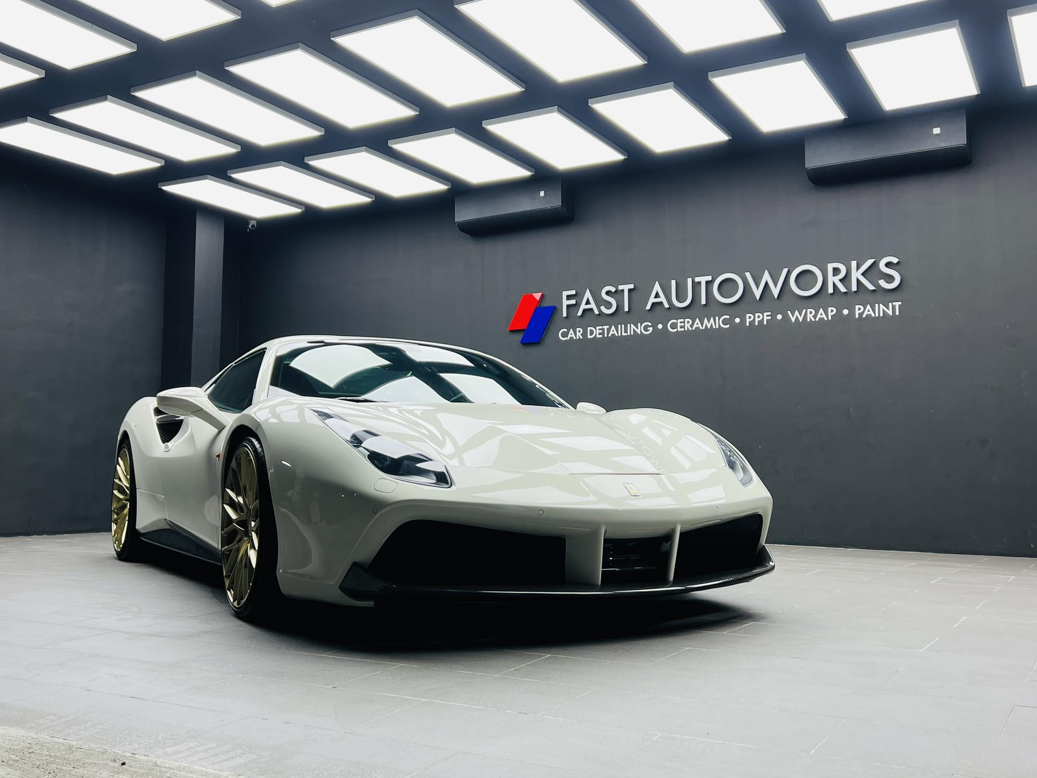 FAST Autoworks technician applying paint protection film to a white car. Description: Precision work at FAST Autoworks Parañaque, where every detailing and wrapping job is handled with care and skill. Whether you are looking to restore your ride’s shine or give it a completely new look, the Parañaque branch offers a full suite of services: Paint Protection Film (PPF) – Protects against scratches, chips, and daily wear Wraps – Instantly transform your vehicle’s look without a full paint job Tint – For comfort, UV protection, and a sleek finish Paint Services – From touch-ups to full resprays Auto Detailing – Meticulous cleaning inside and out Ceramic Coating – Long-lasting gloss and advanced paint protection